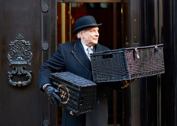Staff at the Wolseley entrance with two hampers